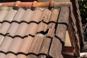 Cracked roof tiles showing deterioration that HOA preventive maintenance can help identify and address