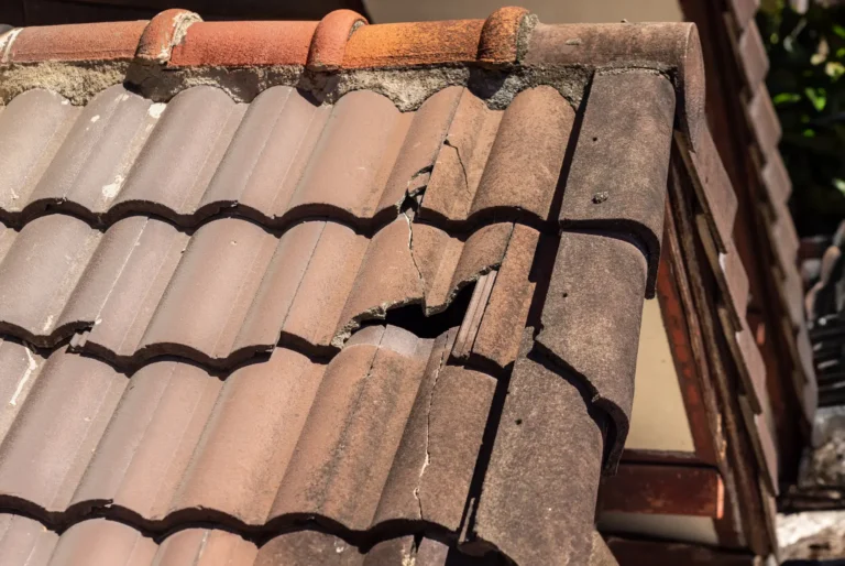 Cracked roof tiles showing deterioration that HOA preventive maintenance can help identify and address